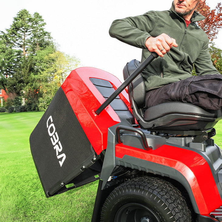 Man operating the Cobra grass box emptying handle on a Cobra premium lawn tractor 