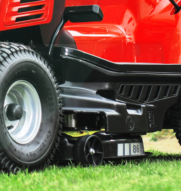 Close-up of Cobra lawn tractors anti-scalp wheels on grass