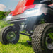 Close-up of the front of a Cobra ride on,  red and black lawn mower on grass with a clear sky.