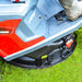Close-up of a Cobra LTX66HRL lawn mower Mulch discharge on grass with a boot visible.