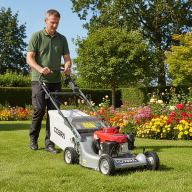 Cobra walk behind Mower with Honda engine being pushed by a gardener in a garden