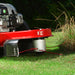 Cobra WT56B Wheeled trimmer cutting grass with a close-up of the engine and blade.