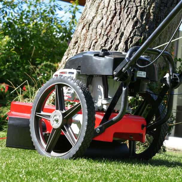 Cobra WT56B Wheeled trimmer rear view against a tree in a grassy area