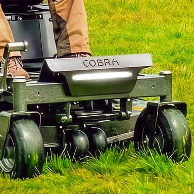 Gardening tool with 'Cobra' branding on a grassy background