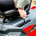 Person adjusting height on a red and gray vehicle seat