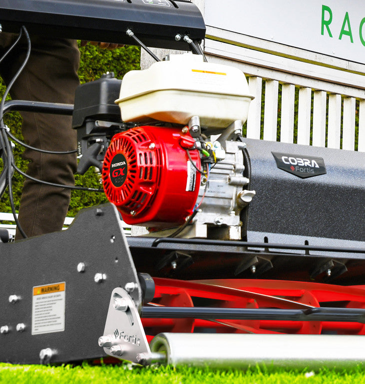 Close-up of a Cobra  Fortis Stadium honda GX engine on grass.