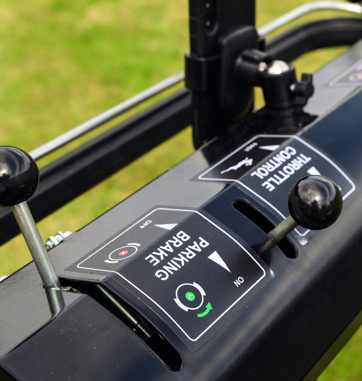 Cobra Fortis Stadium 34'. Close up of Control throttle and brake levers, with grass in the background