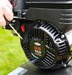 Close-up of a  briggs and straton being started via the pull cord starter. All against a grassy background.