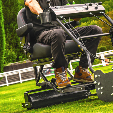  Cobra fortis 34'. Person using a trailed seat attachment on a grassy area.