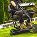 Cobra Fortis 34' Stadium trailed seat. Man riding seat on grass.