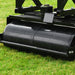 Cobra Fortis trailed seat. Close-up of a rear wheel/  lawn roller on grass.