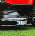 Close-up of a cobra ride on lawn tractorcutting deck on grass.