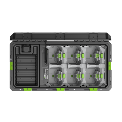 The CHU6000 MULTI-PORT CHARGING UNIT. A top-down view of a rugged black and gray battery storage case with eight gray battery modules arranged in two rows, each with bright green connectors, and a molded foam insert compartment on the left side.