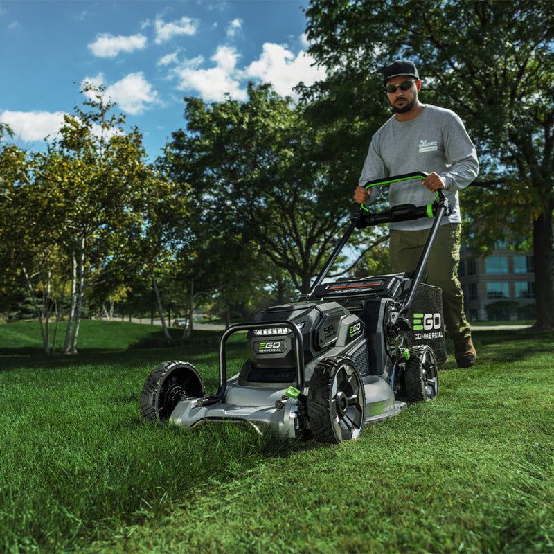 Man operating an EGO lawn mower in a park setting