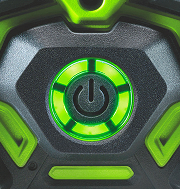 Close-up of a green power button on a black surface