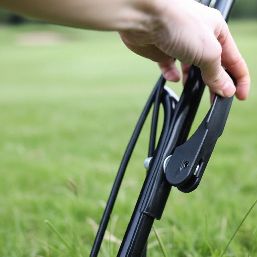 Hand adjusting quick release folding handle on a fortis lawnmowerwith a blurred background 
