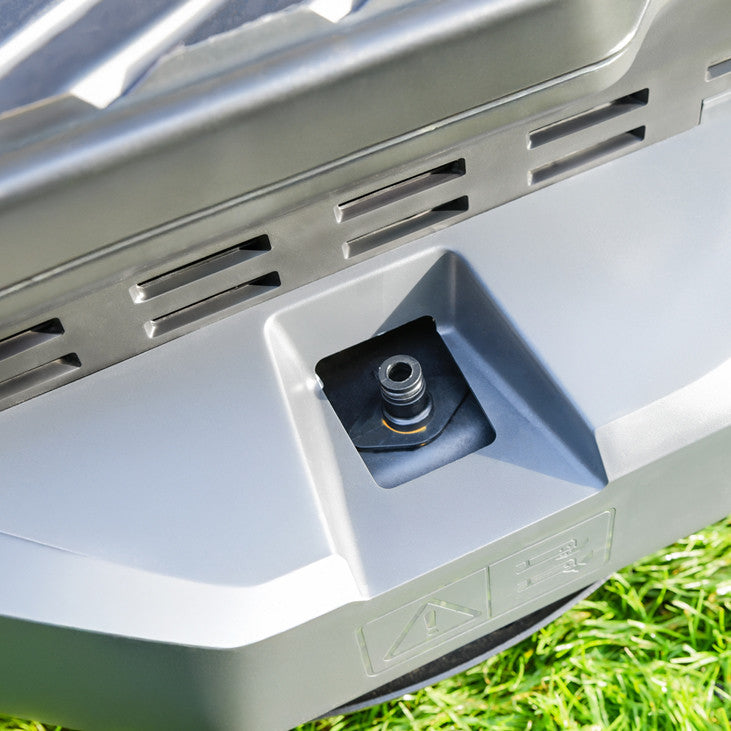 Close up of the deck cleaning port on a Cobra premium ride on lawn tractor with a grass background.