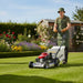  Cobra lawn mower with model number RM53SPH. Being pushed by a gardener 