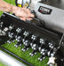 Close-up image of a  hand removing a Cobra Fortis lawn aeration tool on grass